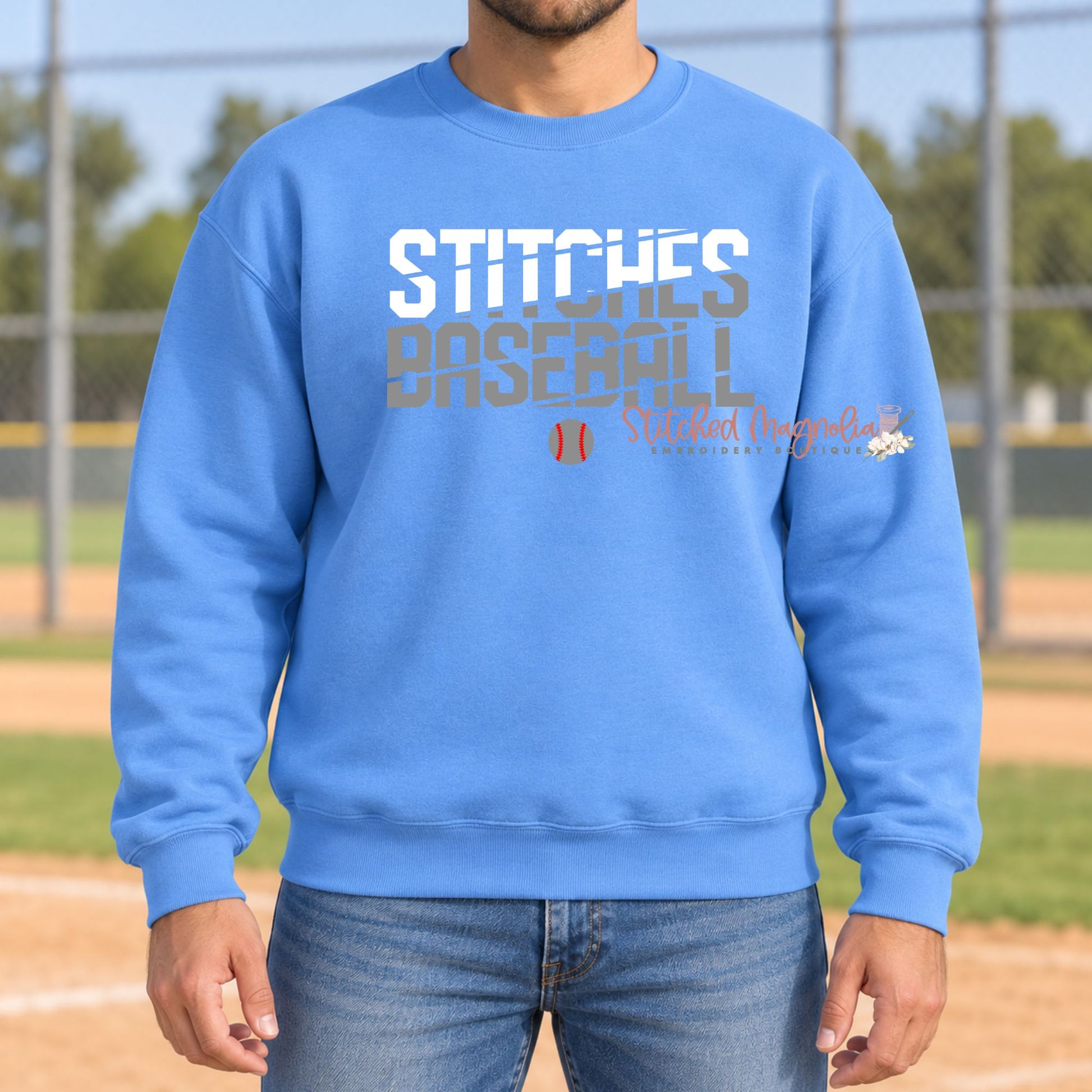 Blue Stitches Baseball crewneck sweatshirt with white and gray slash lettering and a small baseball graphic.