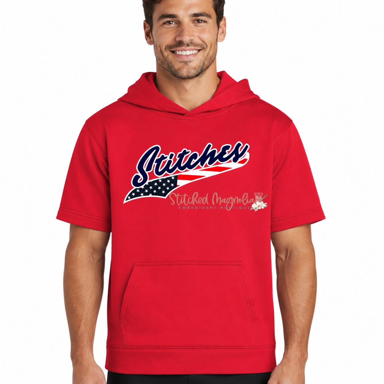 Adult male wearing red Stitches America short sleeve hoodie with navy script and American flag swoosh by Stitched Magnolia