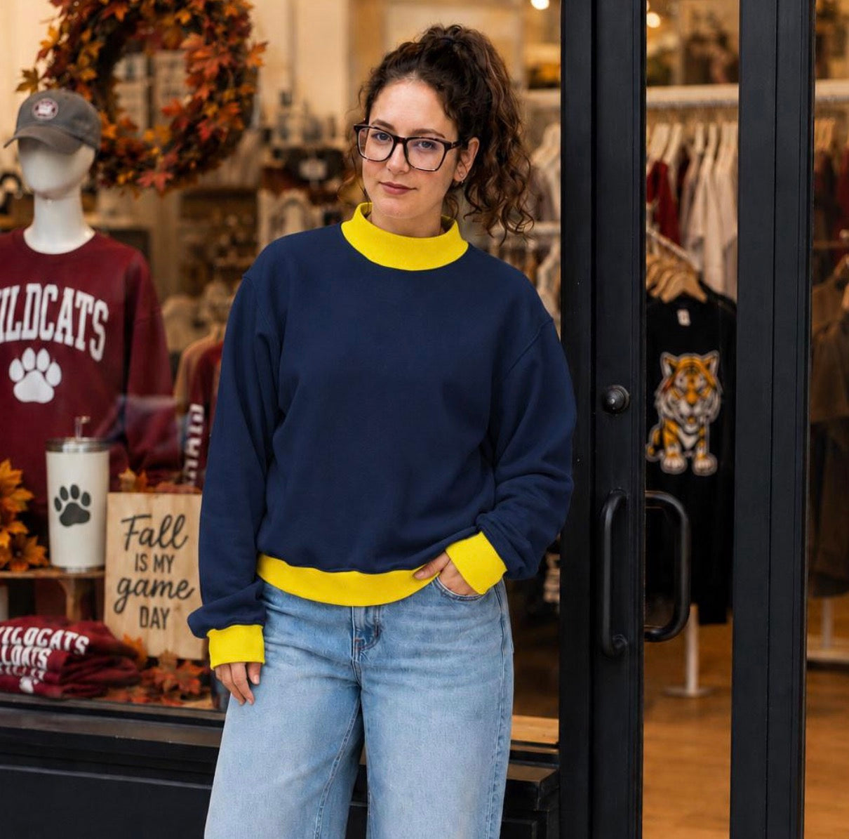 Model wearing royal blue and white contrast mock neck sweatshirt
