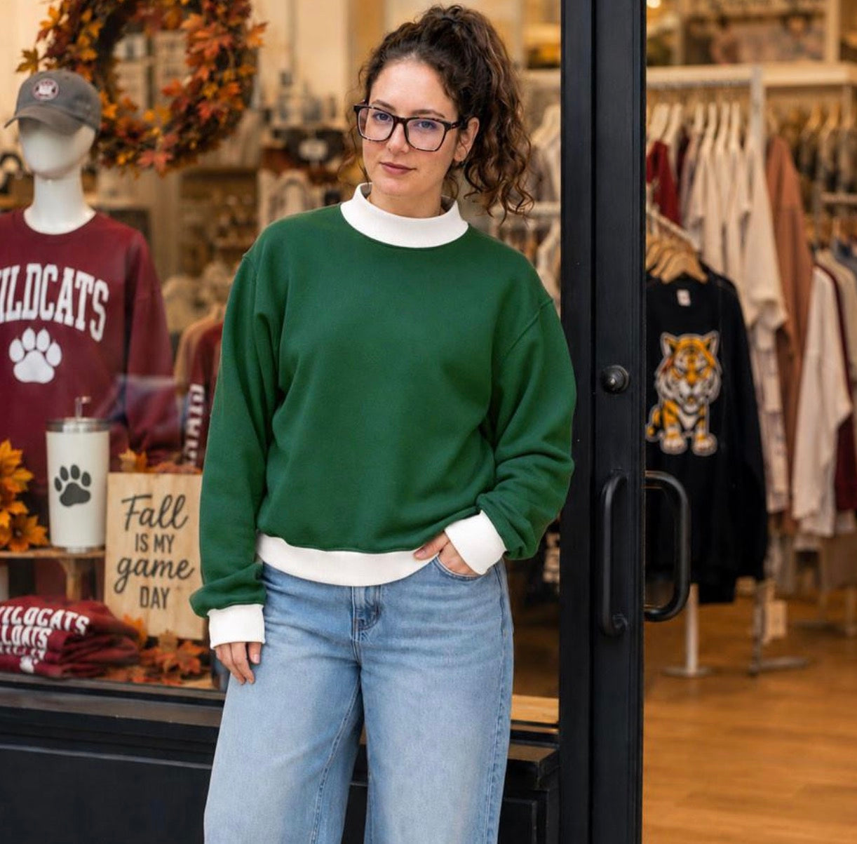 Model wearing maroon and white contrast mock neck sweatshirt