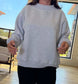Model wearing navy and gold contrast mock neck sweatshirt