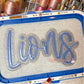 Blue and silver glitter Lions double stack appliqué with stitched outlines on an ash grey sweatshirt