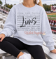 Ash grey Lions Strong Brave graphic sweatshirt with black Lions script layered over team-inspired word art.